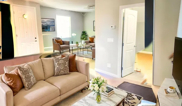 a living room with furniture and wooden floor