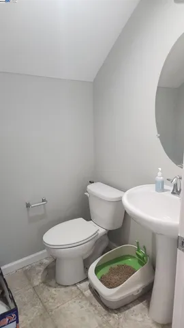 a white toilet sitting next to a bathroom sink