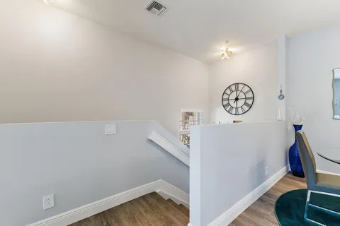 a view of storage and utility room with wooden floor