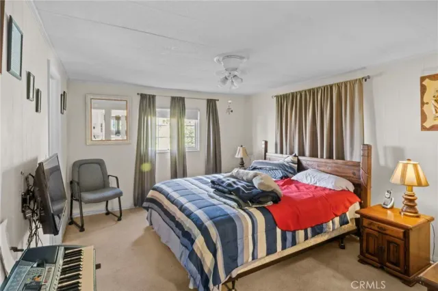 a bedroom with a bed chair and dresser