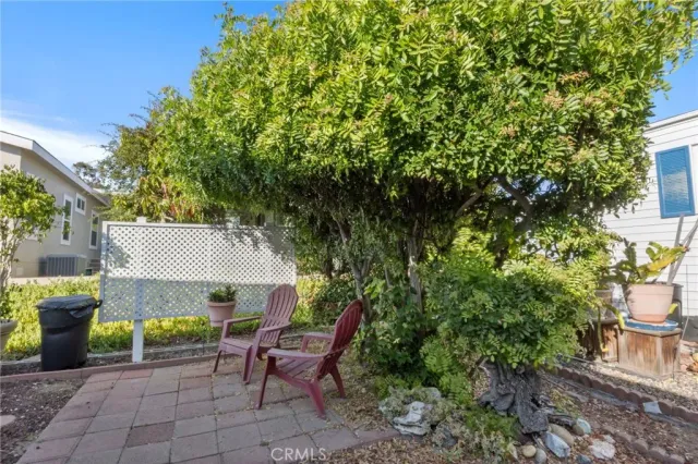 a backyard of a house with table and chairs
