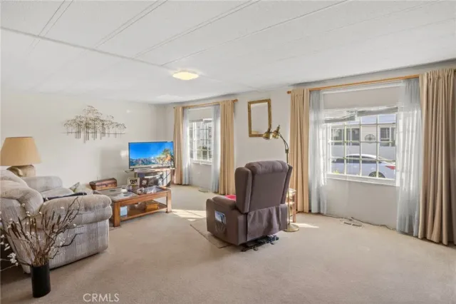 a living room with furniture a fireplace and a window