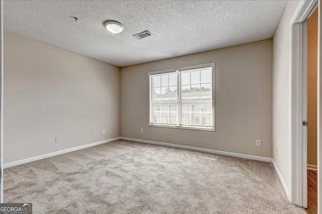 an empty room with a empty space and windows