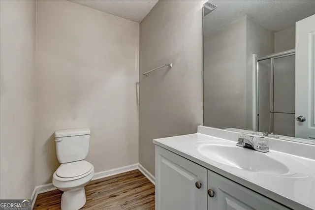 a bathroom with a sink toilet and a mirror