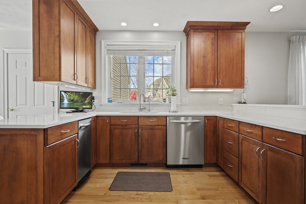 36 Caldwell Farm Road, Unit 36 Newbury, MA 01922 - Photo 12 of 42 a kitchen with stainless steel appliances granite countertop wooden cabinets a sink and dishwasher