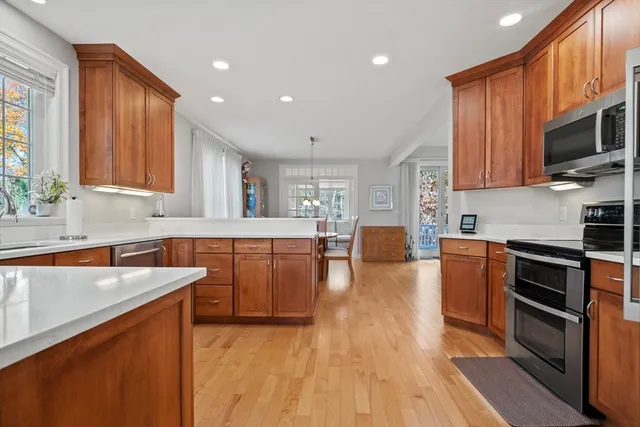 a dining room with furniture a chandelier and wooden floor