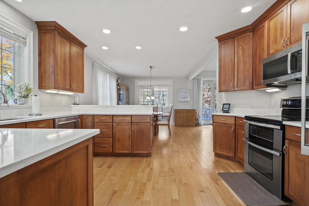 36 Caldwell Farm Road, Unit 36 Newbury, MA 01922 - Photo 13 of 42 a kitchen with stainless steel appliances granite countertop wooden cabinets a stove top oven a sink and dishwasher