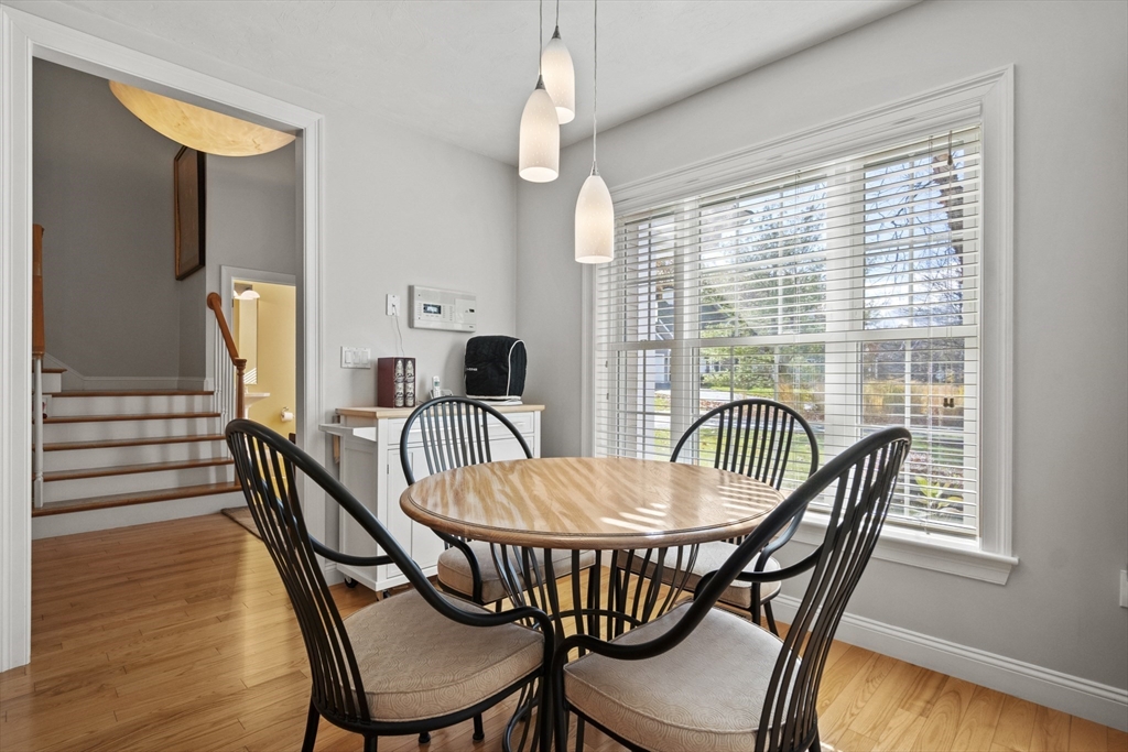36 Caldwell Farm Road, Unit 36 Newbury, MA 01922 - Photo 15 of 42 a dining room with furniture a chandelier and wooden floor