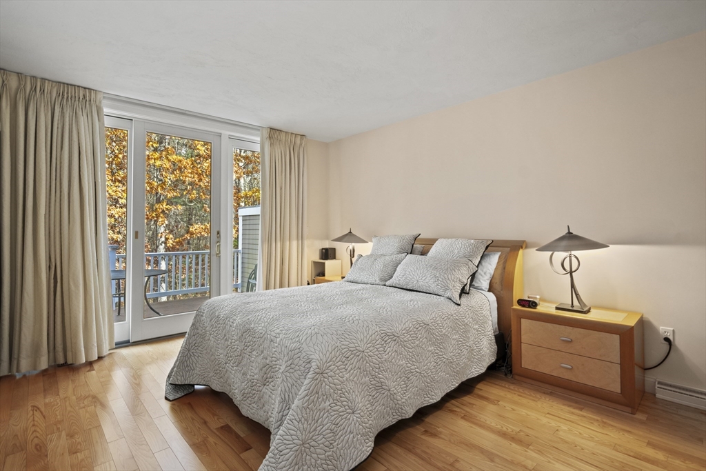 36 Caldwell Farm Road, Unit 36 Newbury, MA 01922 - Photo 19 of 42 a bed room with a bed and a large window