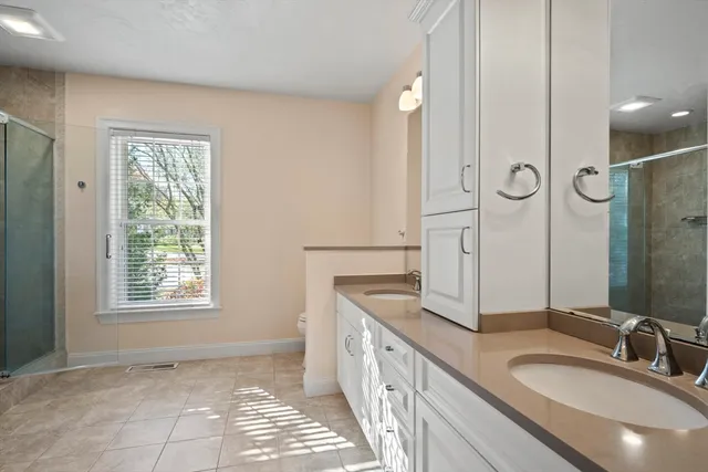a bathroom with a sink a toilet and a mirror