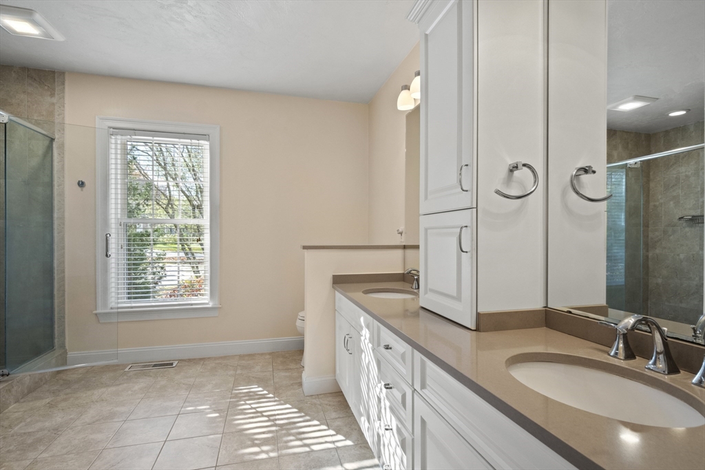 36 Caldwell Farm Road, Unit 36 Newbury, MA 01922 - Photo 21 of 42 a bathroom with a granite countertop sink a mirror and a shower