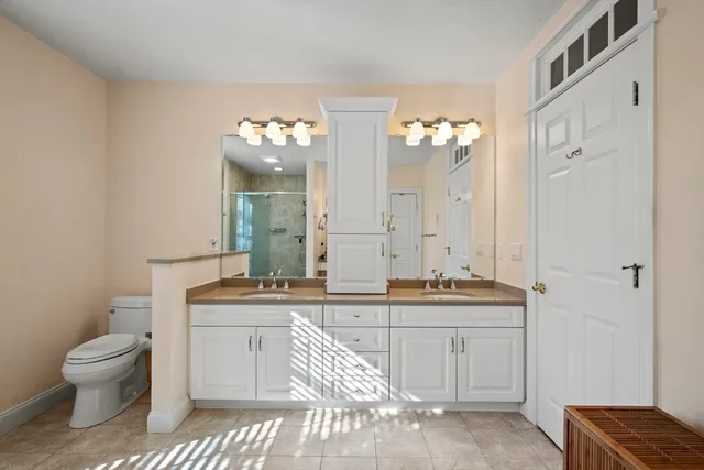 a bedroom with a bed and cabinets