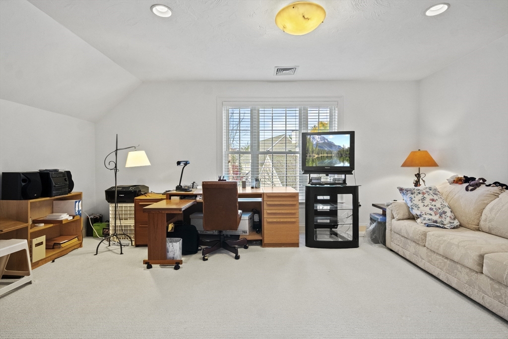 36 Caldwell Farm Road, Unit 36 Newbury, MA 01922 - Photo 27 of 42 a living room with furniture and a flat screen tv