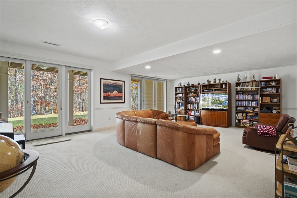 36 Caldwell Farm Road, Unit 36 Newbury, MA 01922 - Photo 30 of 42 a living room with furniture and a flat screen tv