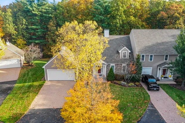 a view of a street sign under a large tree