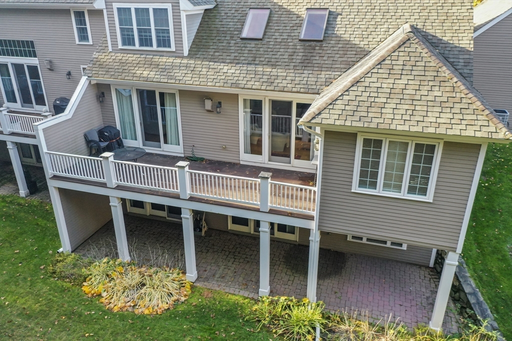 36 Caldwell Farm Road, Unit 36 Newbury, MA 01922 - Photo 40 of 42 a view of a house with a chairs and table in a patio
