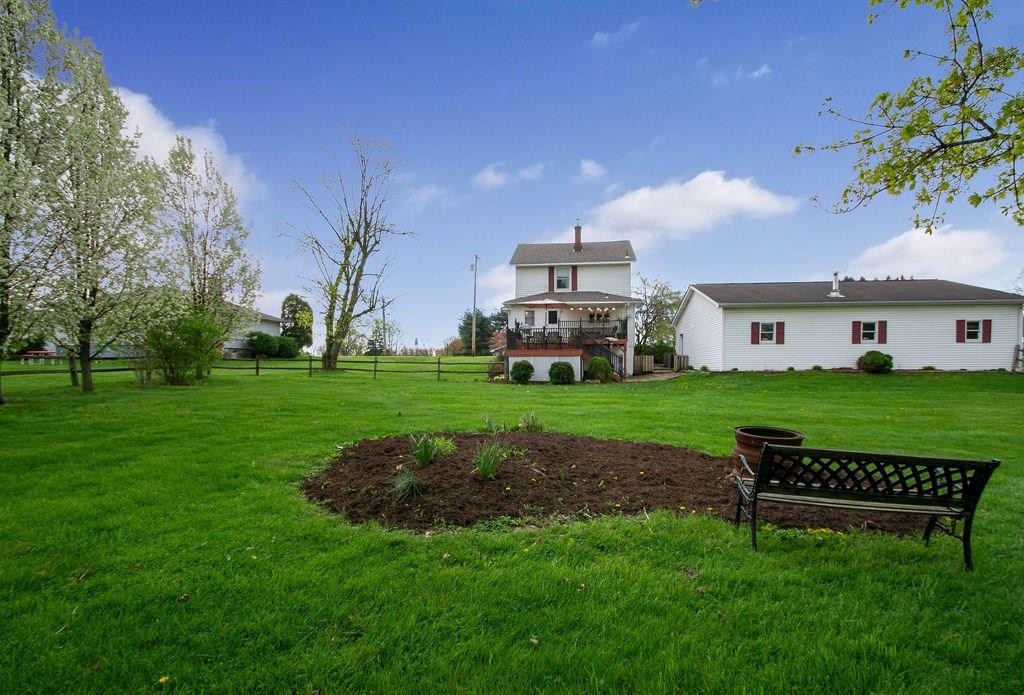251 Winfield Road Sarver, PA 16055 - Photo 3 of 25 The flat backyard has been meticulously landscaped with flowering trees, space for a garden, and is fenced.