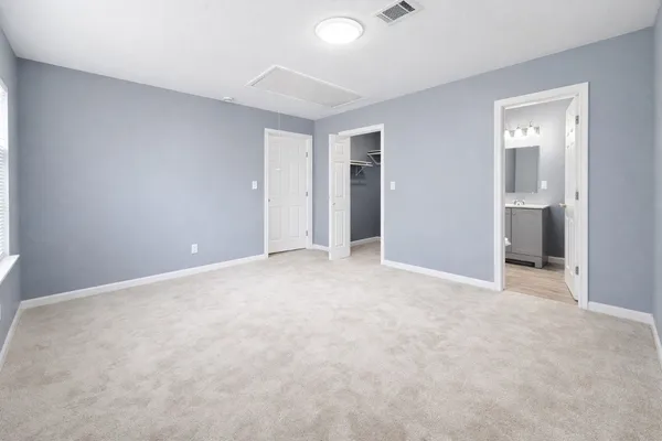 an empty room with closet and bathroom