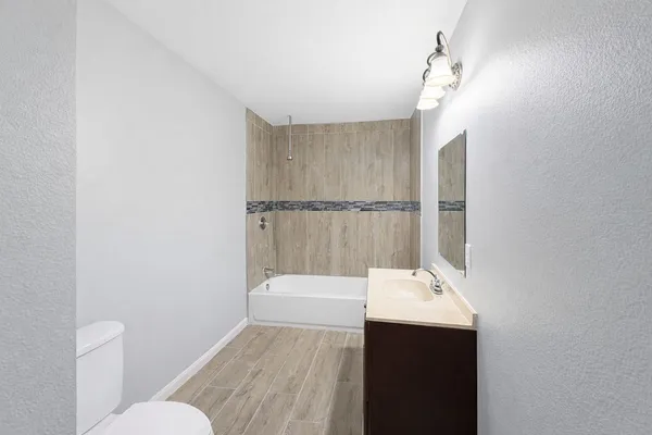 a bathroom with a sink a toilet and mirror