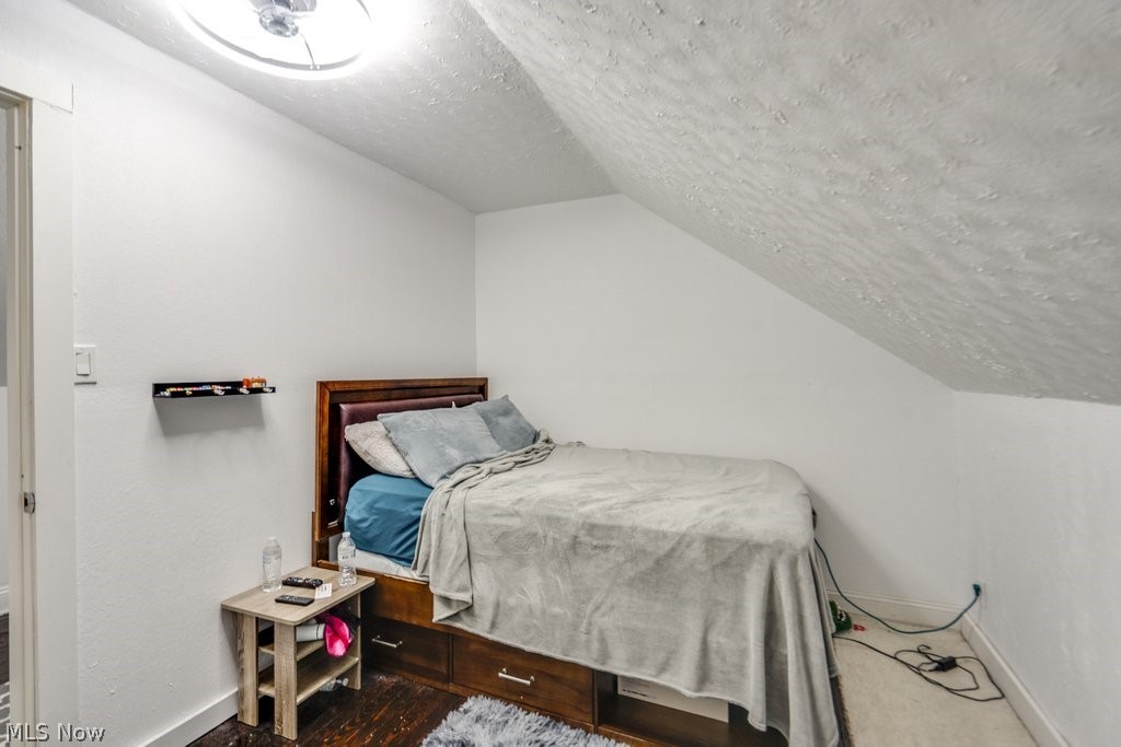 3566 Lloyd Road Cleveland, OH 44111 - Photo 25 of 31 Bedroom featuring a textured ceiling and lofted ceiling