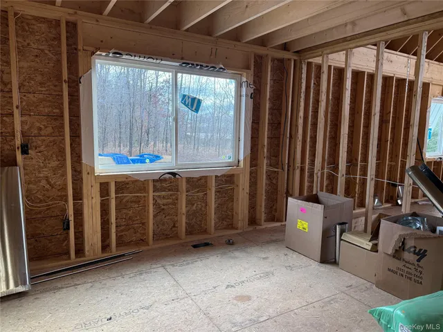 a view of house with wooden stairs and seating area