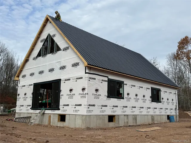 a view of a terrace with white wall