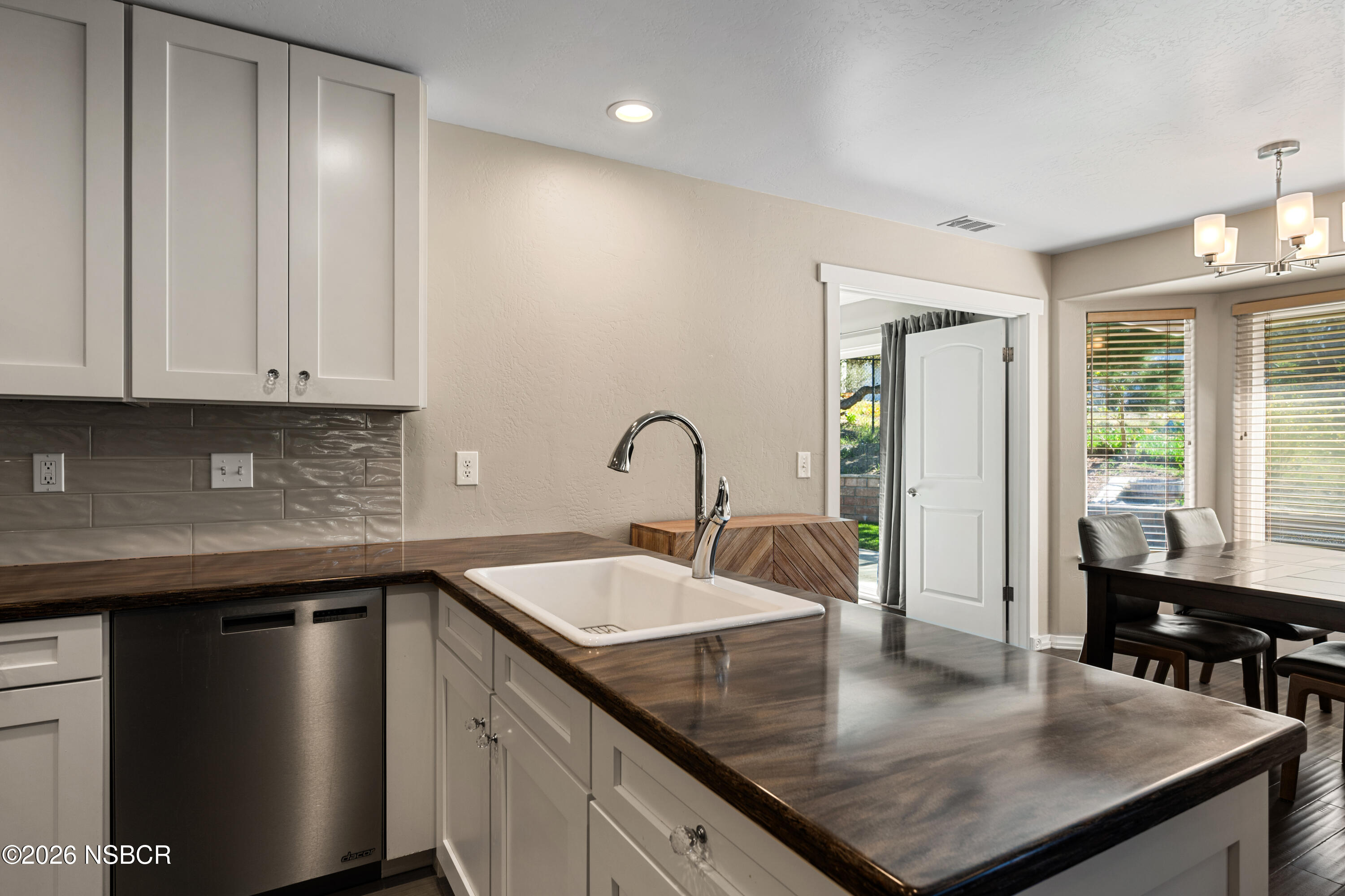 4473 Greenbrier Road Lompoc, CA 93436 - Photo 17 of 54 a kitchen with granite countertop a sink a stove and cabinets