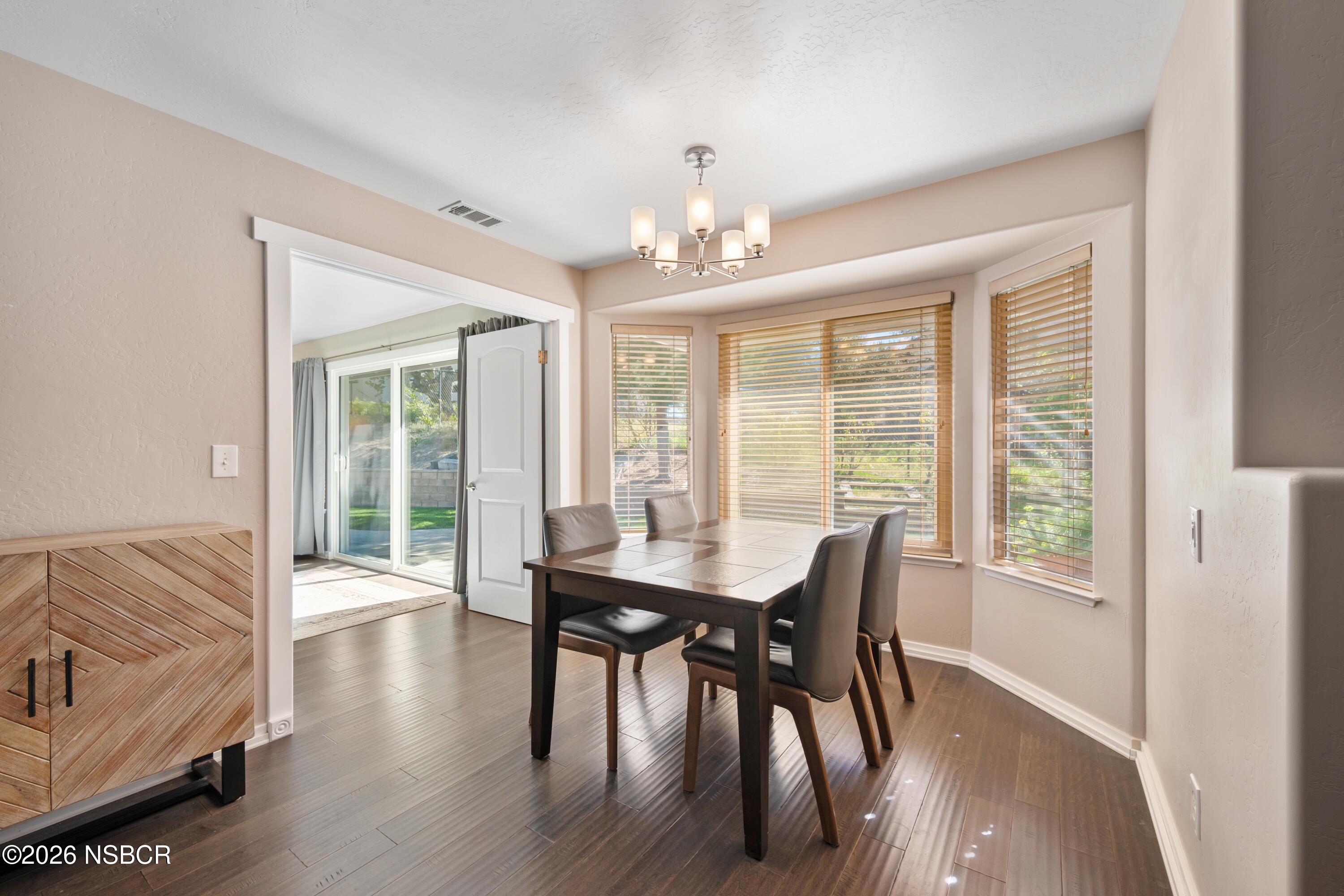 4473 Greenbrier Road Lompoc, CA 93436 - Photo 19 of 54 a view of a dining room with furniture window and wooden floor