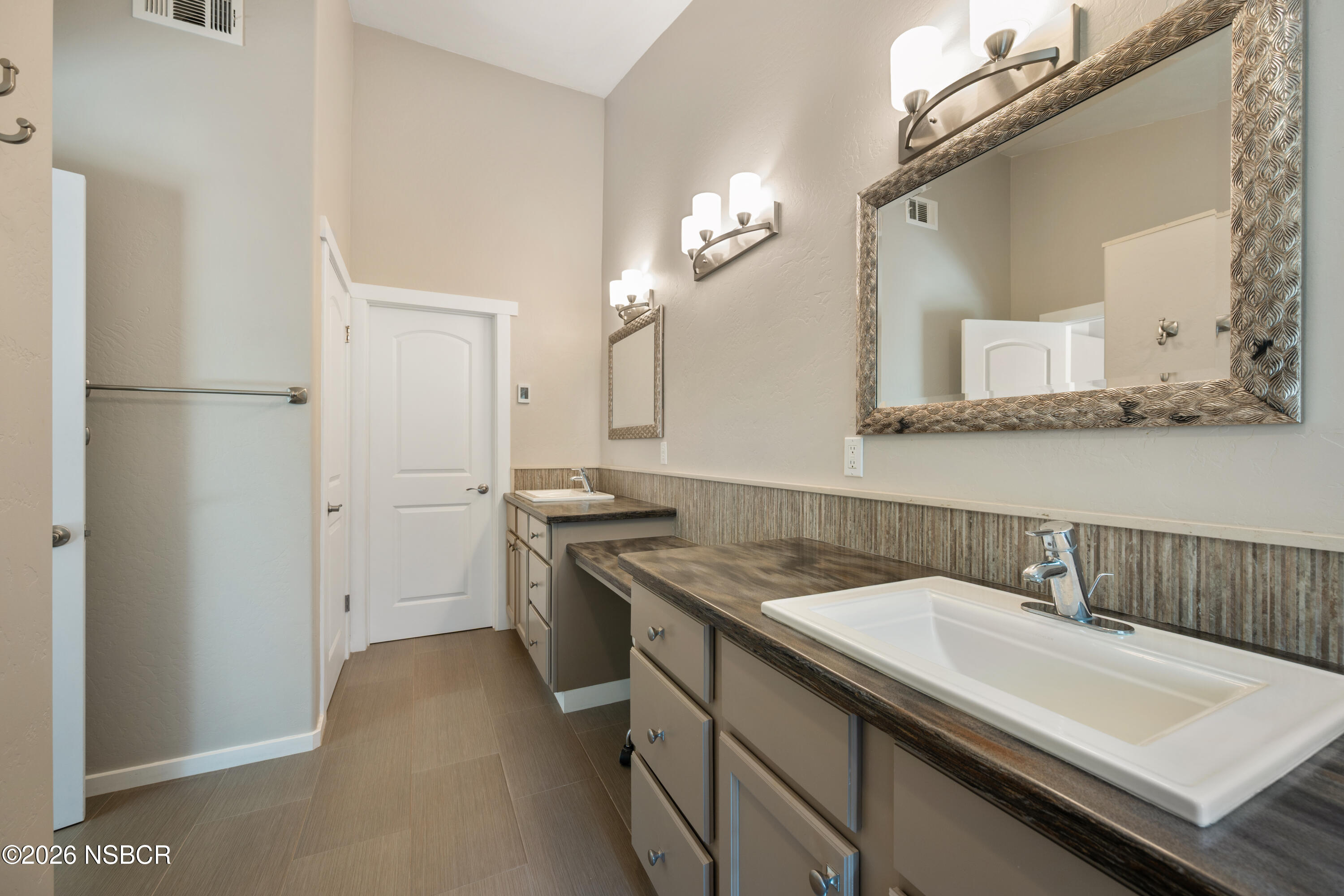 4473 Greenbrier Road Lompoc, CA 93436 - Photo 25 of 54 a bathroom with a sink a vanity and a mirror