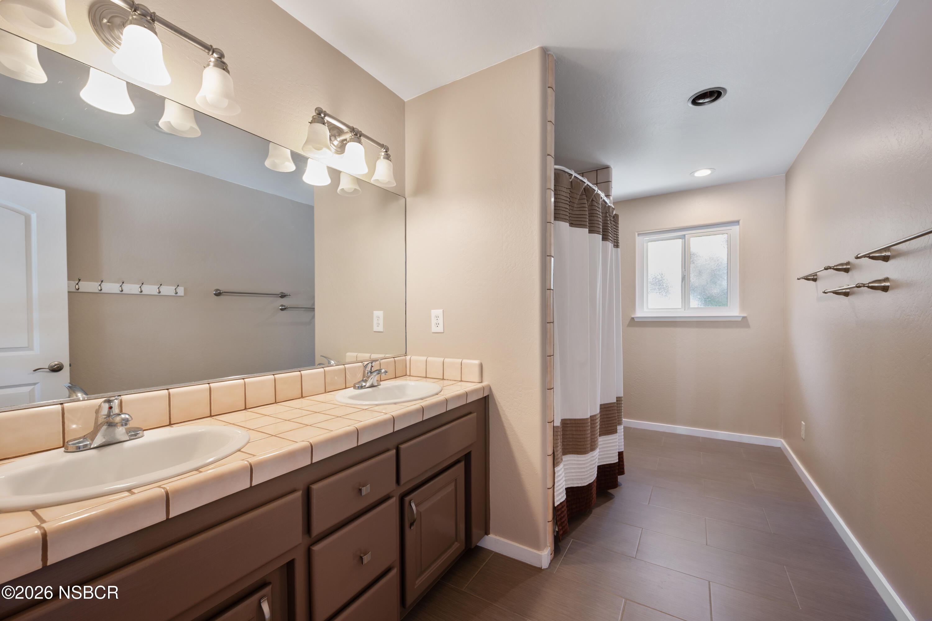 4473 Greenbrier Road Lompoc, CA 93436 - Photo 29 of 54 a bathroom with a double vanity sink and a mirror