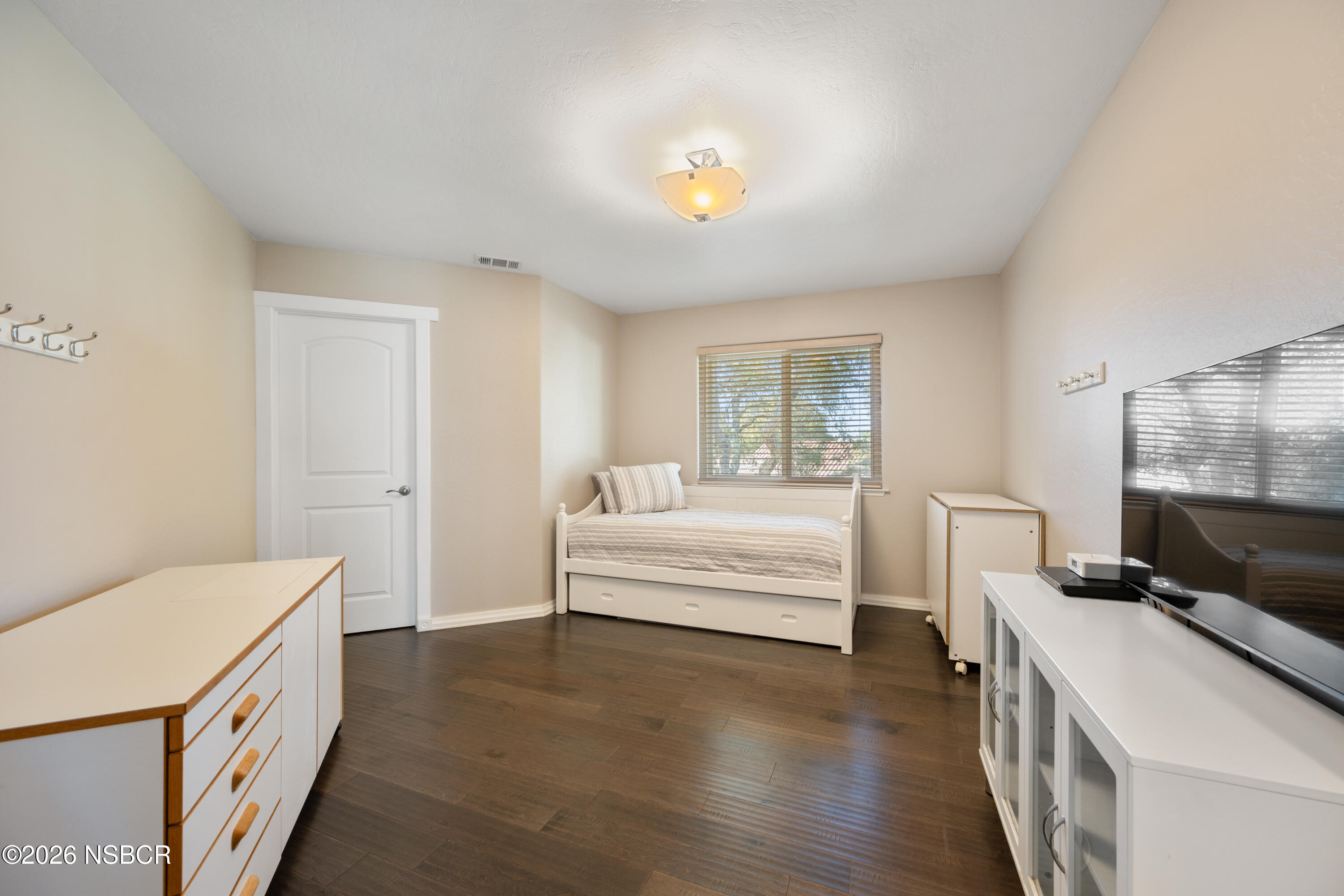 4473 Greenbrier Road Lompoc, CA 93436 - Photo 31 of 54 a bedroom with a bed and a chandelier