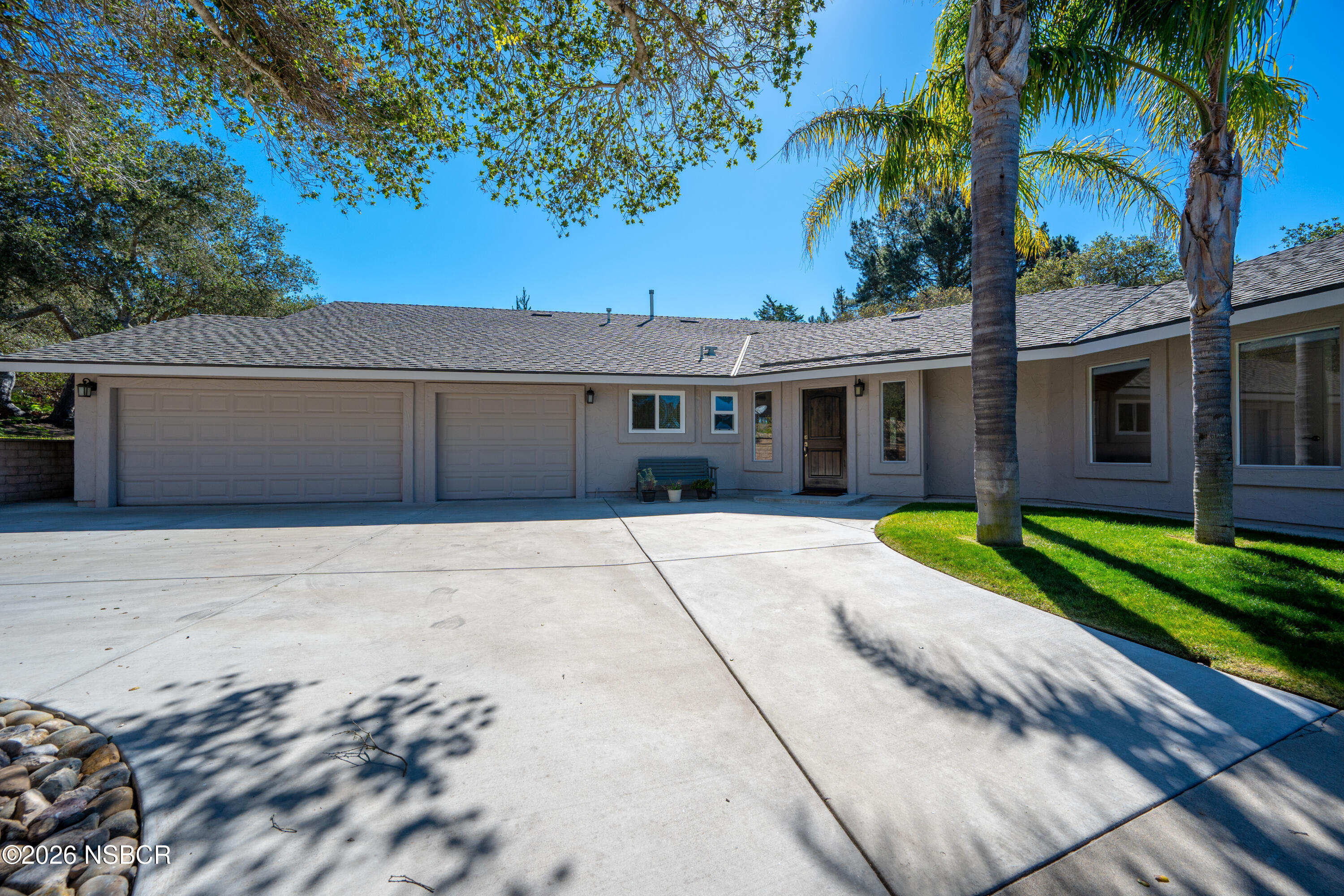 4473 Greenbrier Road Lompoc, CA 93436 - Photo 7 of 54 a view of a house with a yard and palm trees