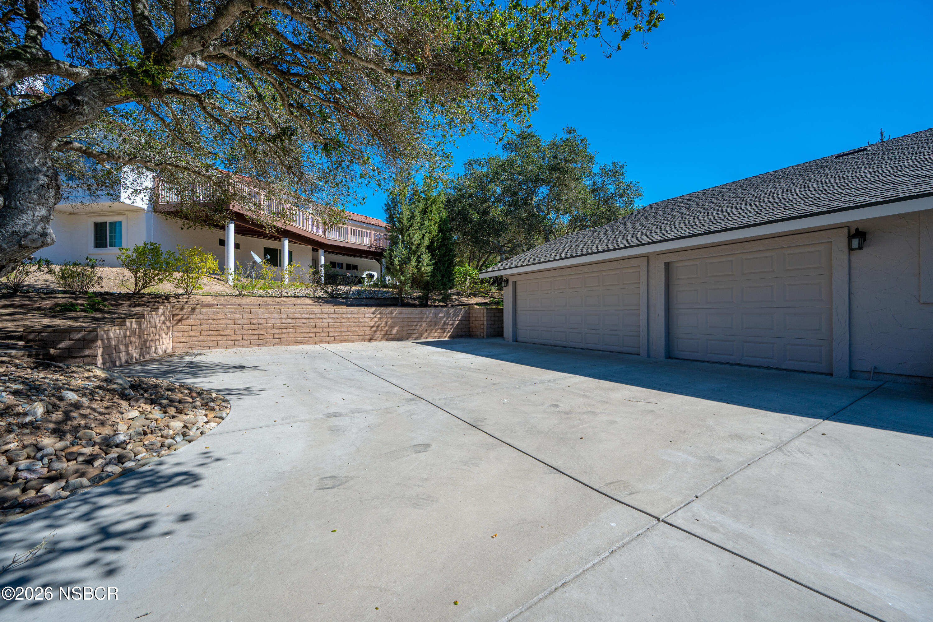 4473 Greenbrier Road Lompoc, CA 93436 - Photo 8 of 54 a front view of a house with a yard and garage