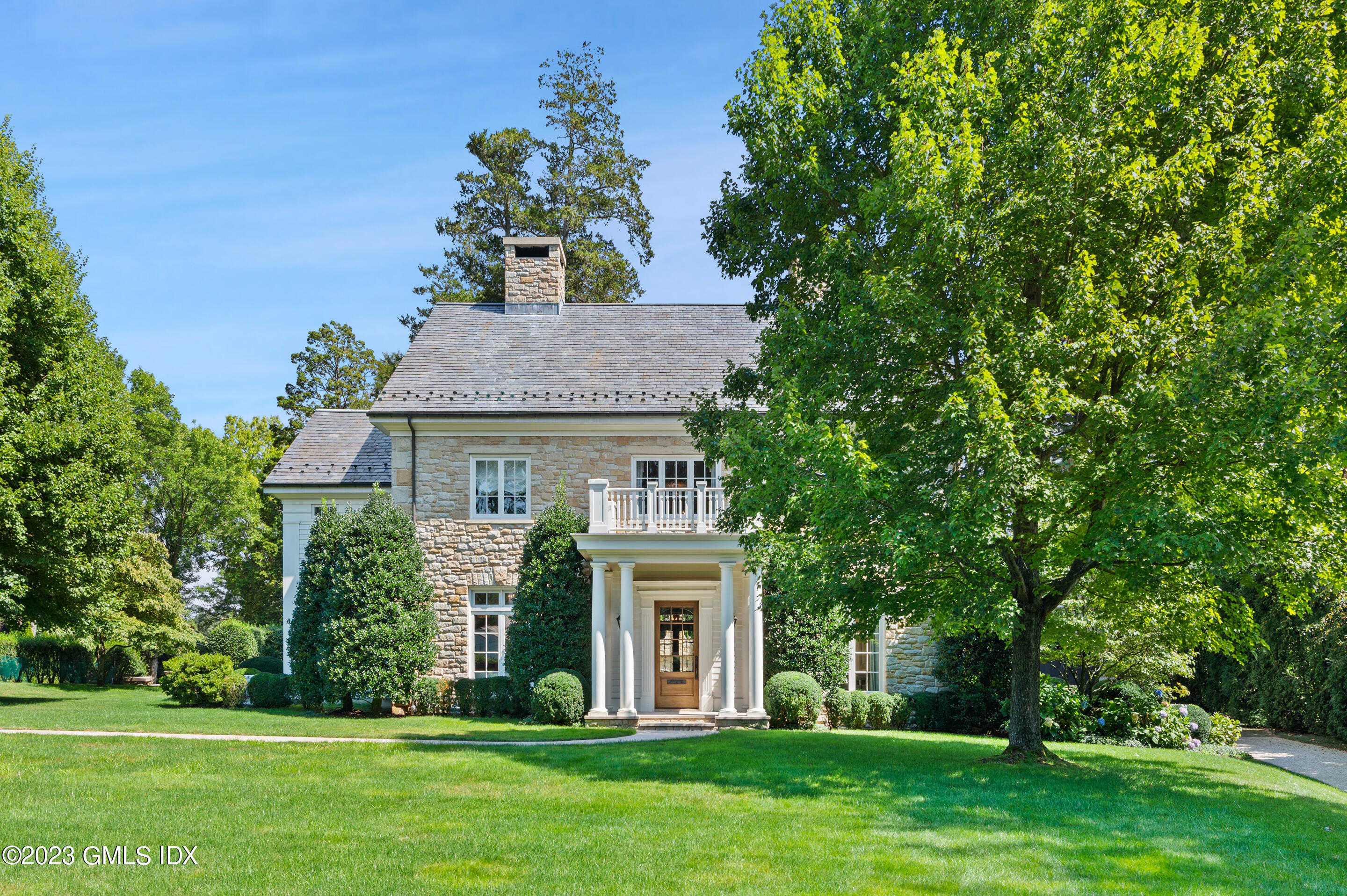 2 Martin Dale Greenwich, CT 06830 - Photo 2 of 53 a front view of a house with a garden
