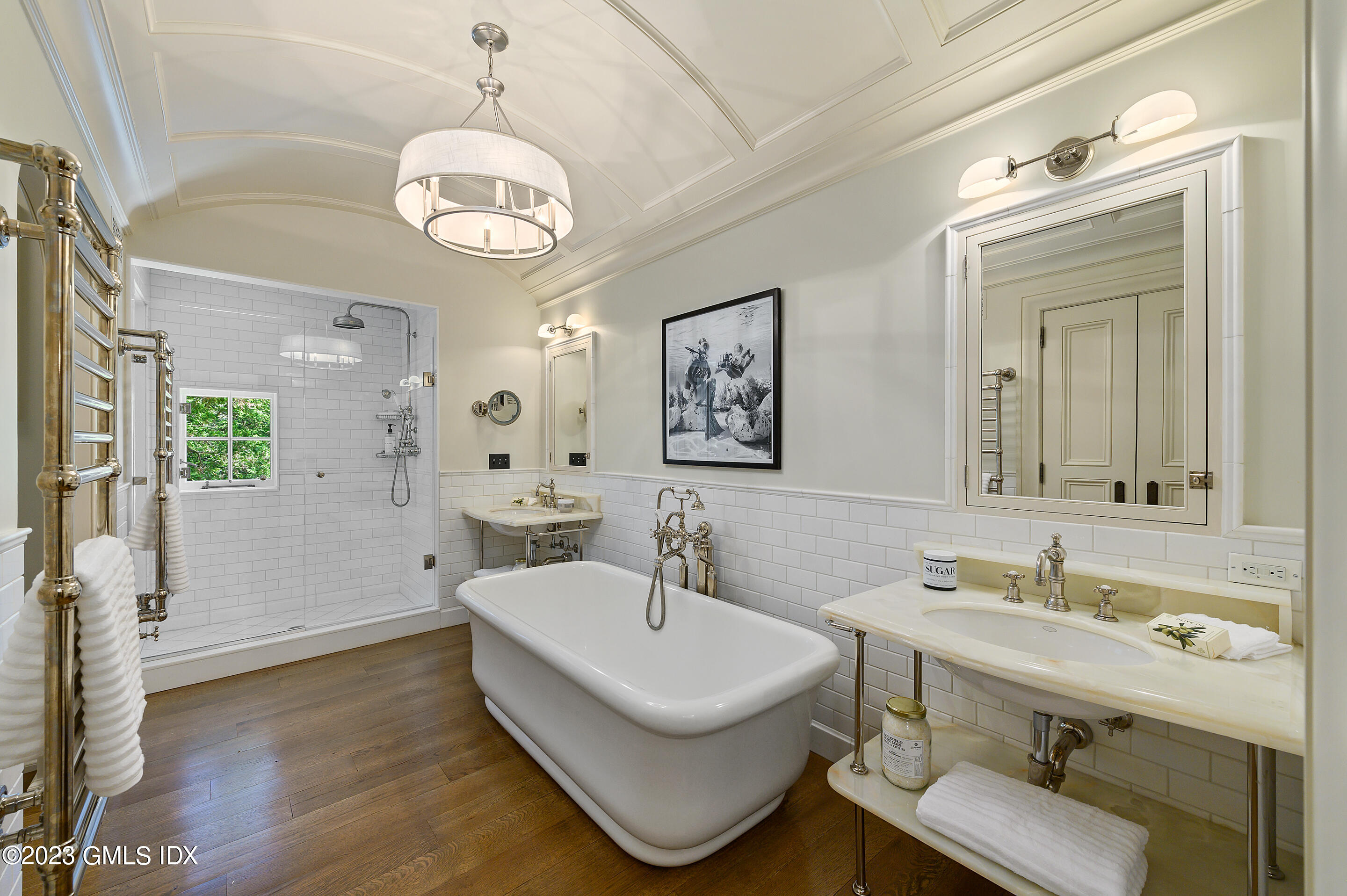 2 Martin Dale Greenwich, CT 06830 - Photo 22 of 53 a bathroom with a sink mirror and a bathtub with a chandelier