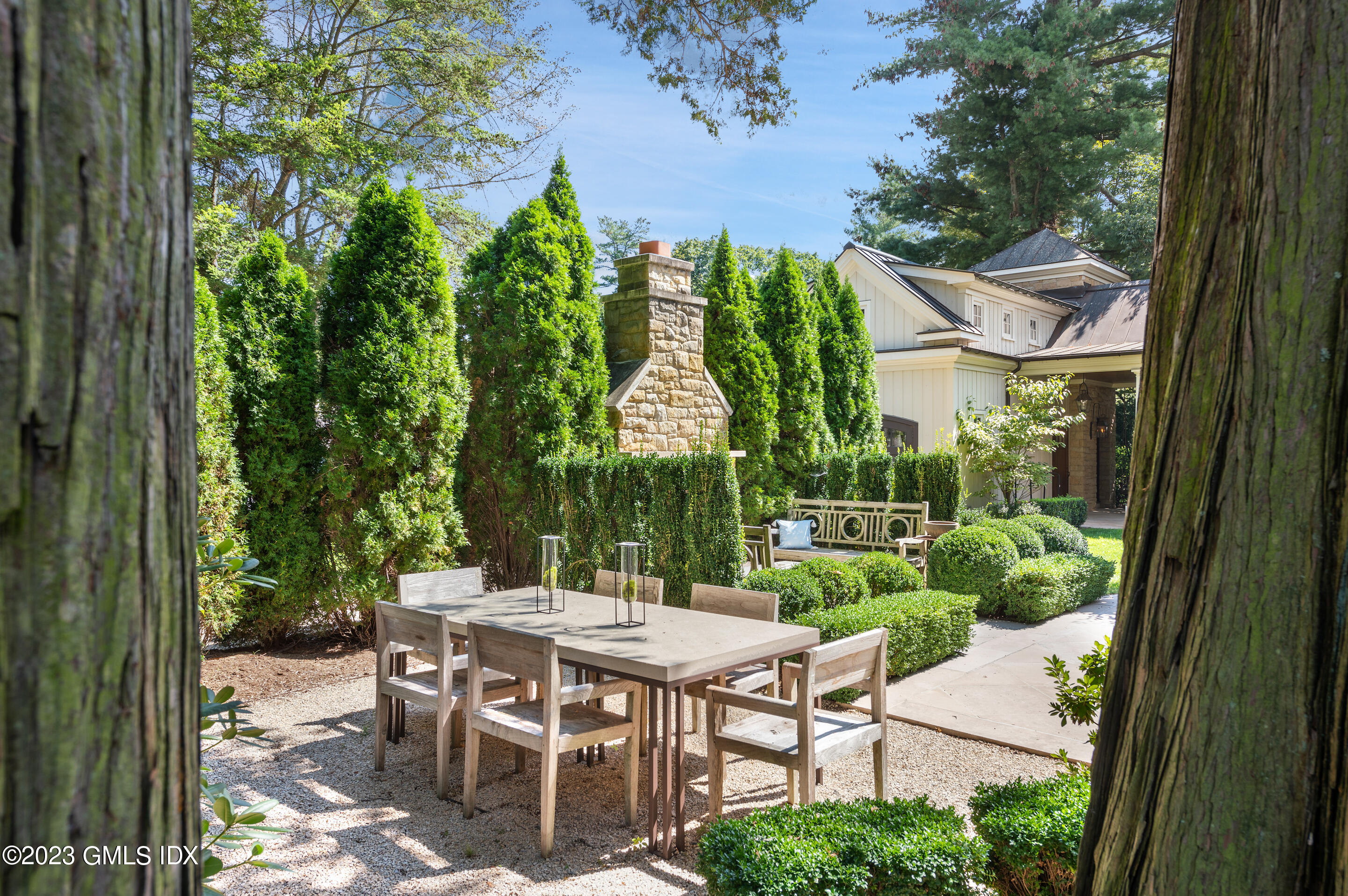 2 Martin Dale Greenwich, CT 06830 - Photo 46 of 53 a view of a patio with table and chairs potted plants and large tree