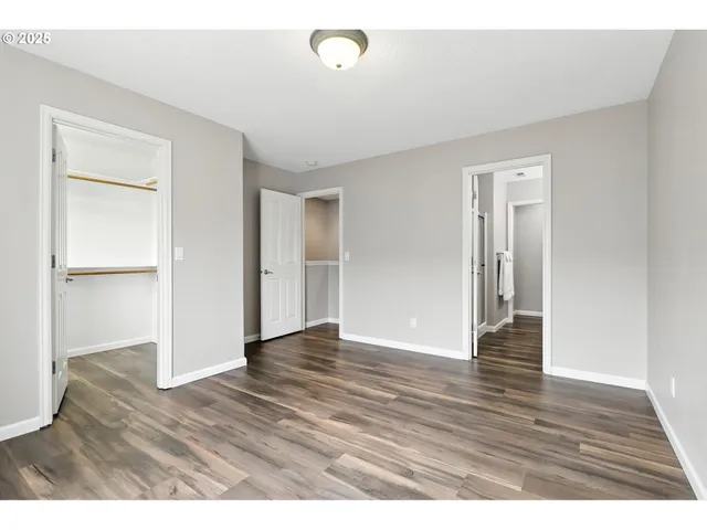a view of an empty room and wooden floor