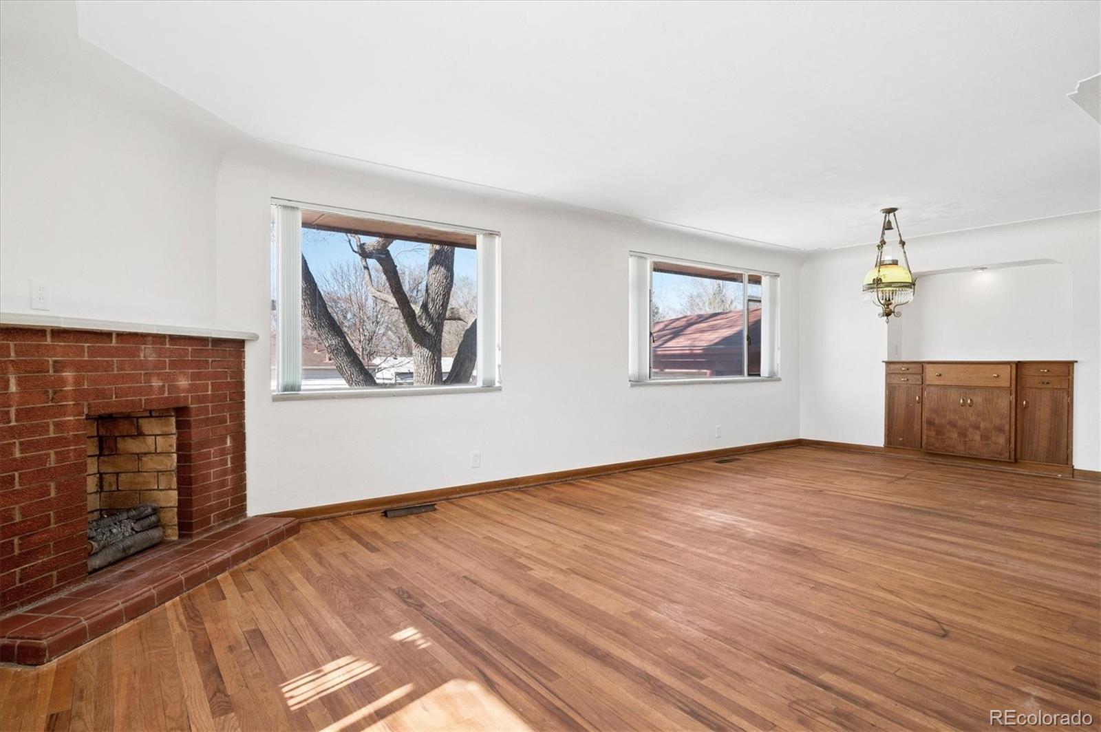 7505 West 47th Avenue Wheat Ridge, CO 80033 - Photo 12 of 35 a view of an empty room with wooden floor and a window