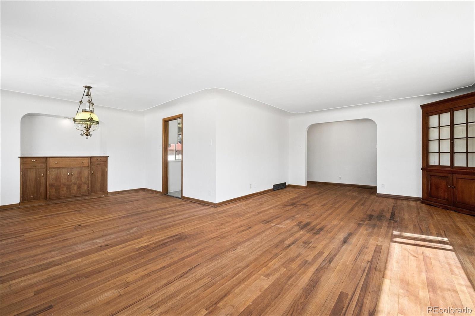 7505 West 47th Avenue Wheat Ridge, CO 80033 - Photo 13 of 35 a view of empty room with wooden floor and fan