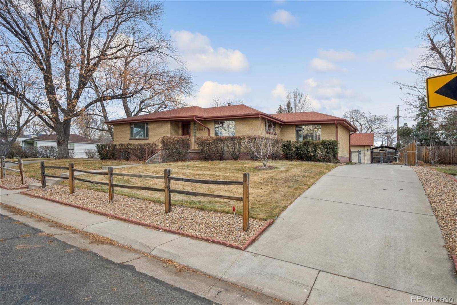 7505 West 47th Avenue Wheat Ridge, CO 80033 - Photo 2 of 35 a front view of a house with a yard