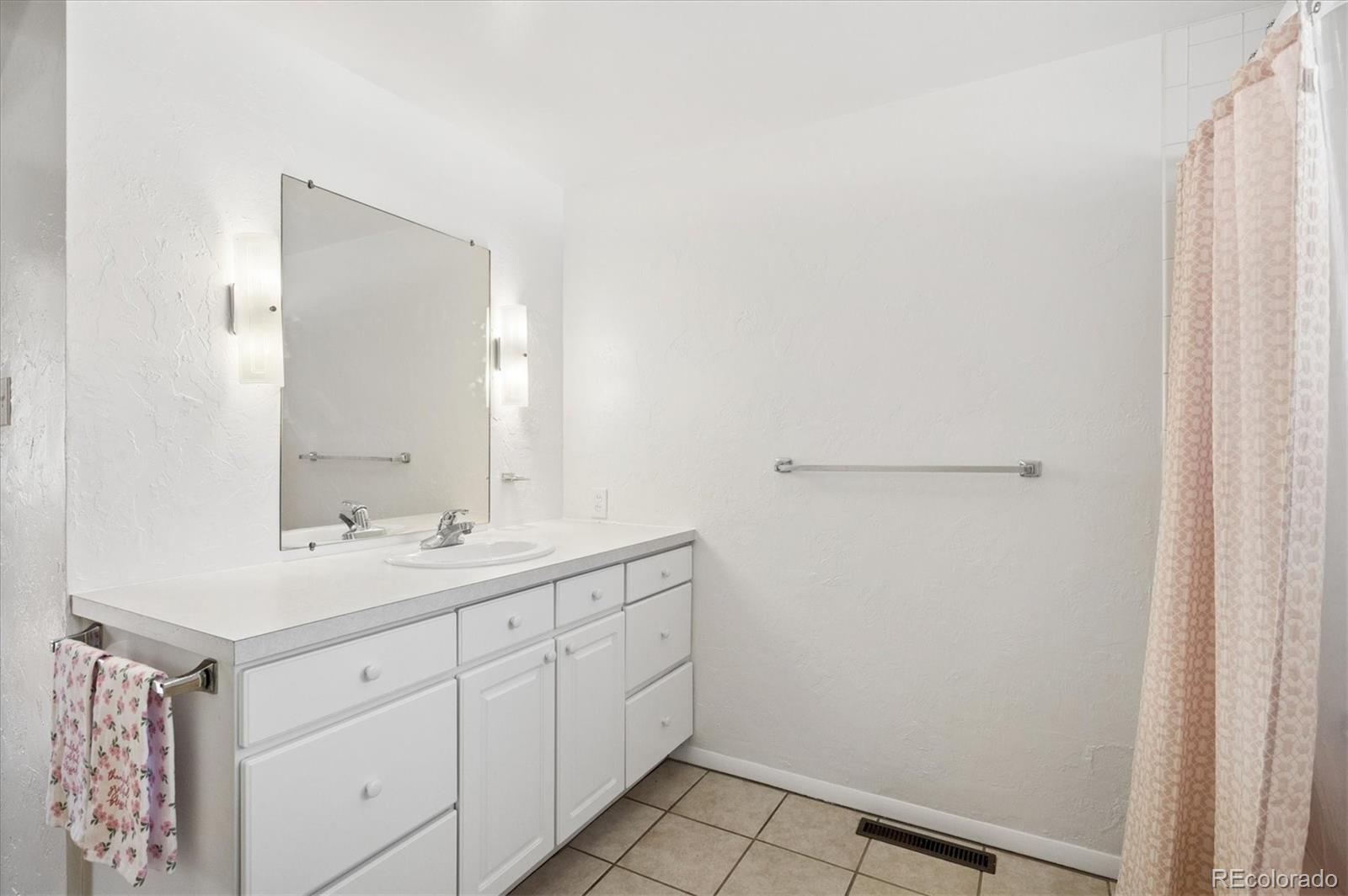 7505 West 47th Avenue Wheat Ridge, CO 80033 - Photo 24 of 35 a bathroom with a sink and a mirror