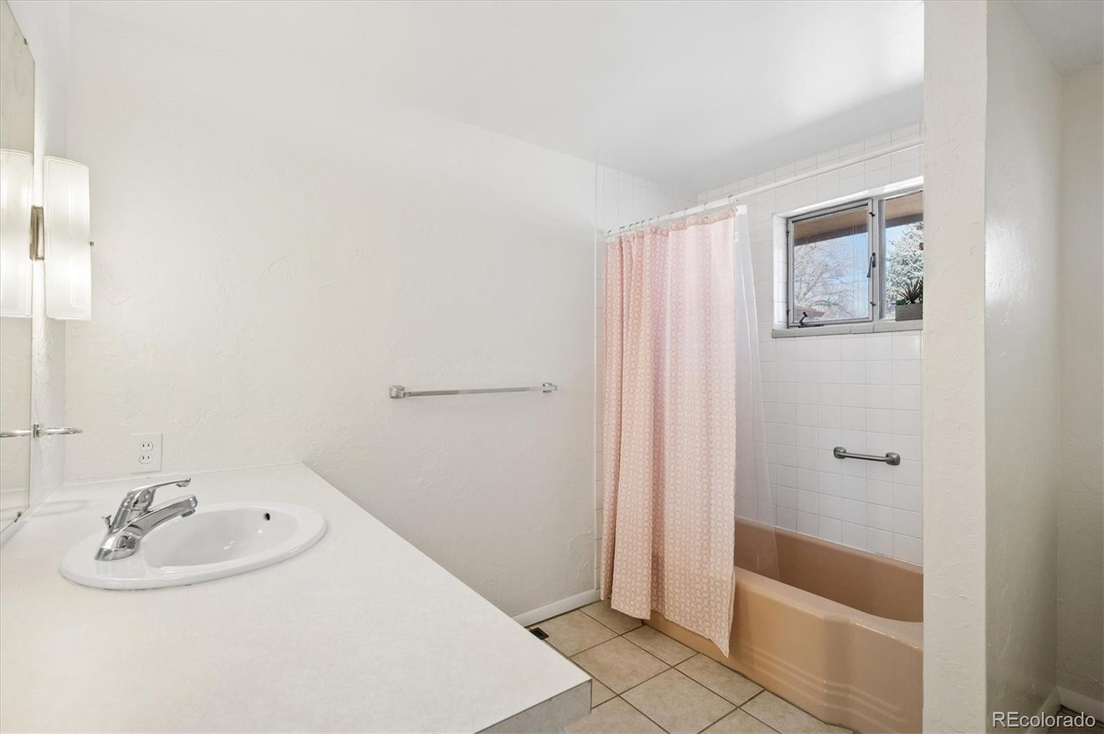 7505 West 47th Avenue Wheat Ridge, CO 80033 - Photo 25 of 35 a bathroom with a sink and a mirror