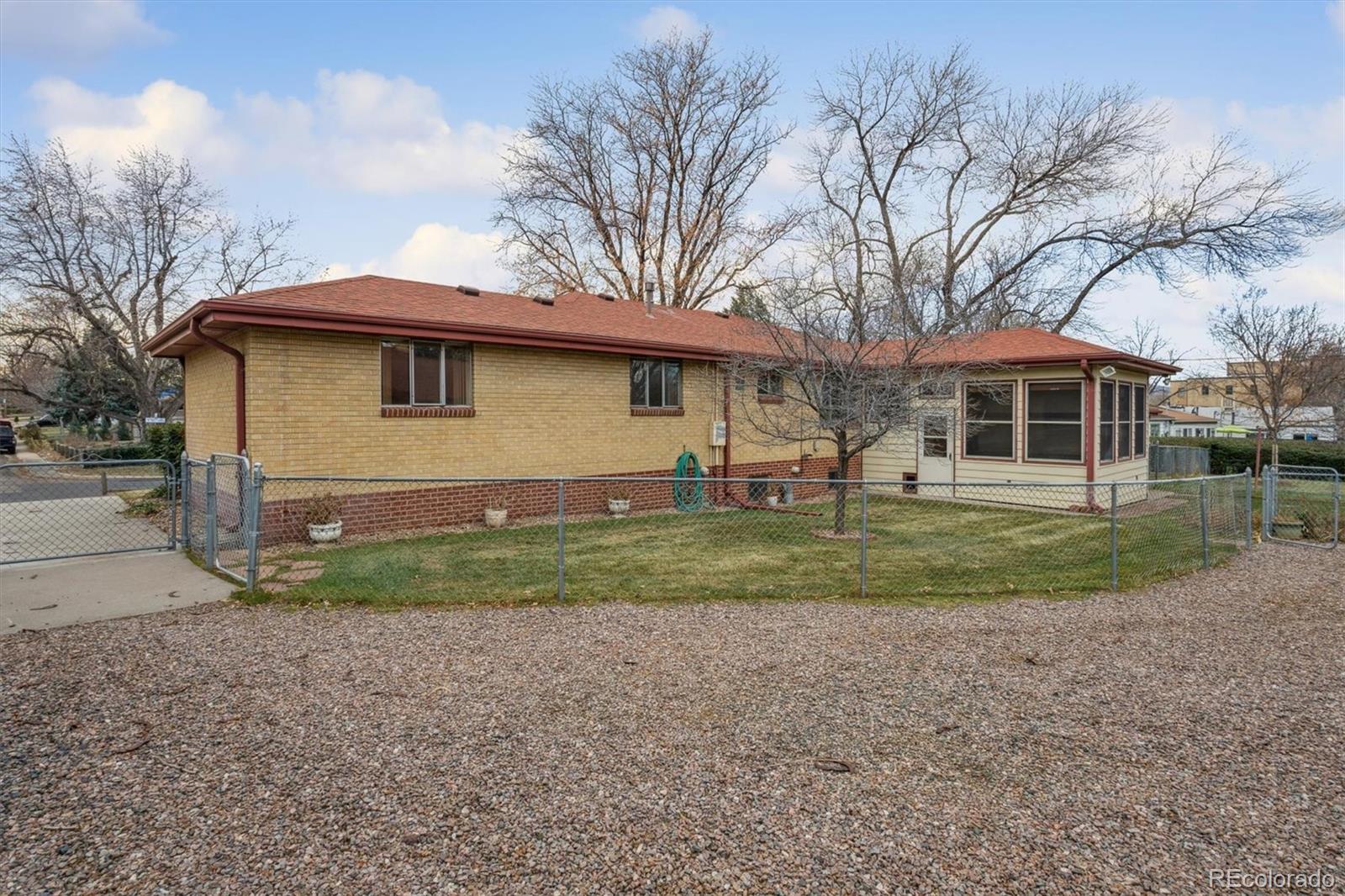 7505 West 47th Avenue Wheat Ridge, CO 80033 - Photo 35 of 35 a front view of a house with a yard and trees