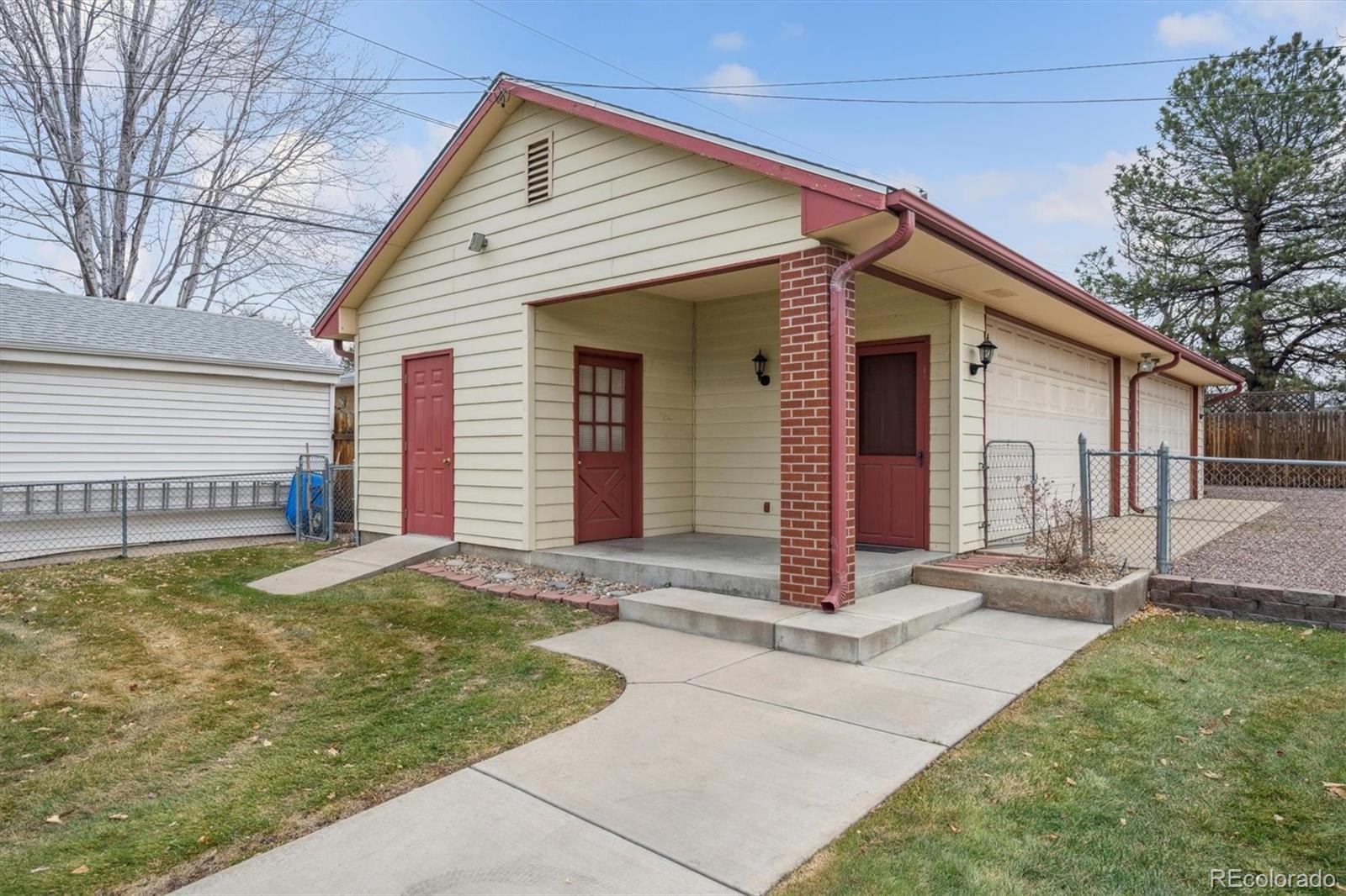 7505 West 47th Avenue Wheat Ridge, CO 80033 - Photo 4 of 35 a front view of a house with porch