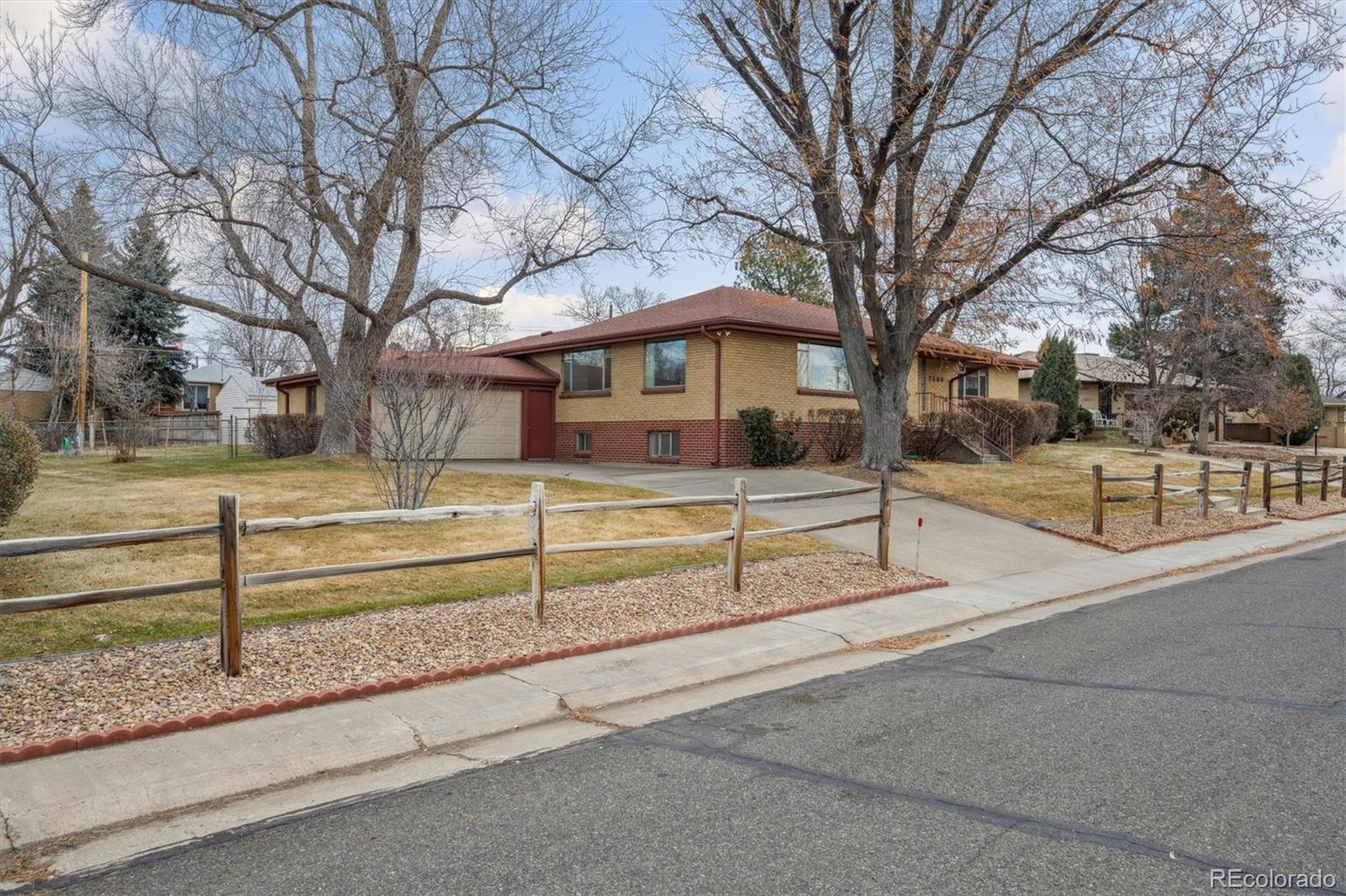 7505 West 47th Avenue Wheat Ridge, CO 80033 - Photo 7 of 35 a view of a house with a yard