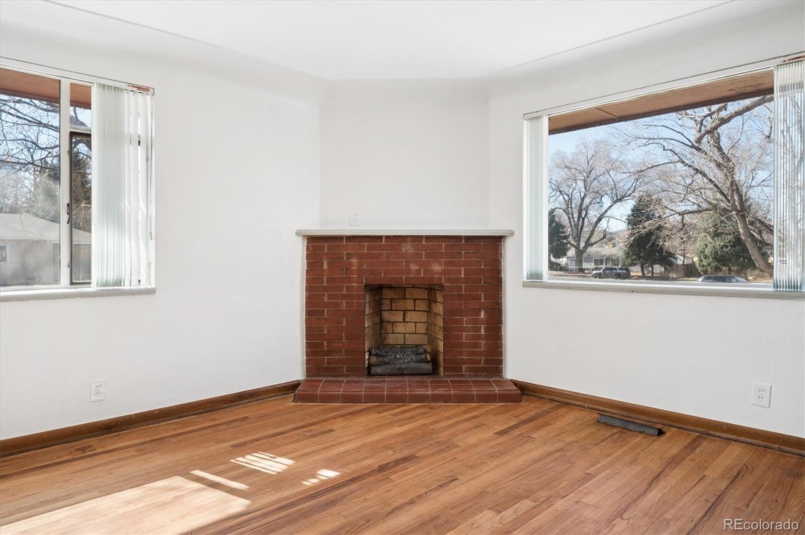 7505 West 47th Avenue Wheat Ridge, CO 80033 - Photo 10 of 35 a view of empty room with wooden floor and fan