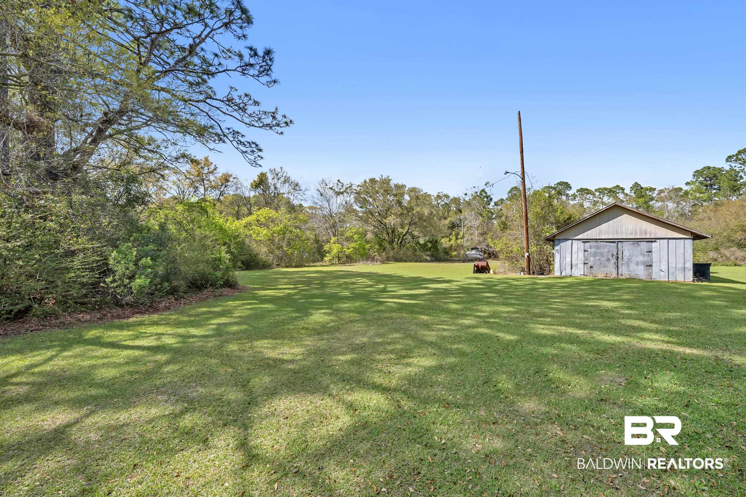 17463 Highway 98 Foley, AL 36535 - Photo 28 of 57 View of grassy yard featuring an outdoor structure