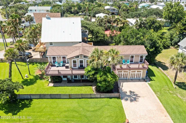 an aerial view of a house with swimming pool garden and patio
