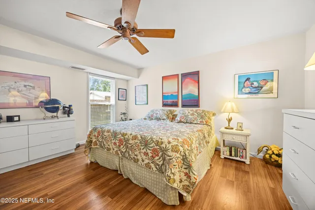 a spacious bedroom with a bed and a flat screen tv