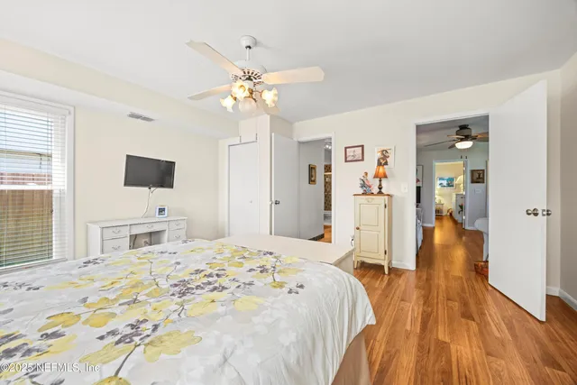 a bathroom with a granite countertop sink a toilet a mirror and shower